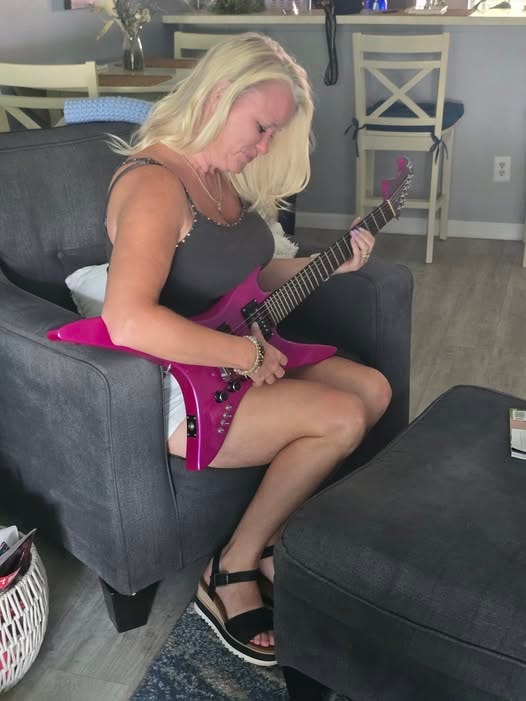 Amanda Katherine Sisson playing guitar