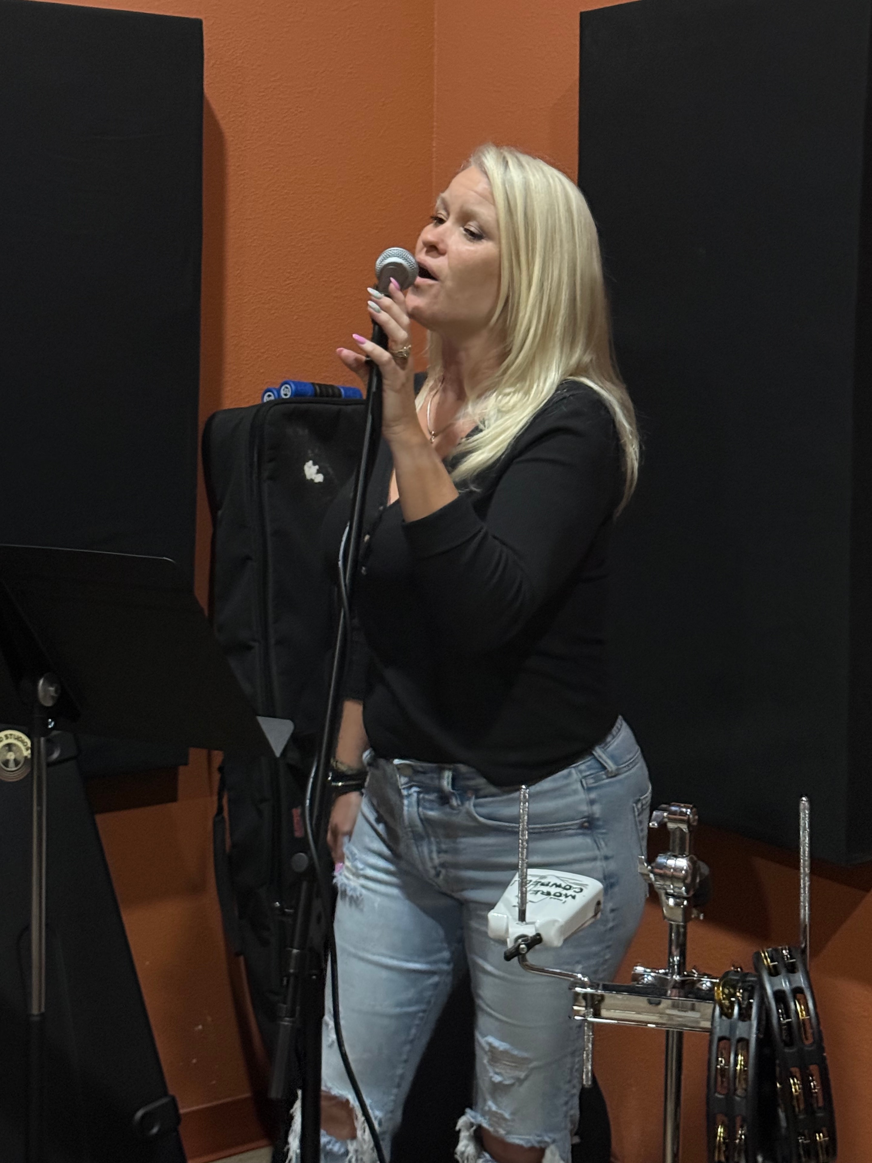 Singer performing with microphone at rehearsal