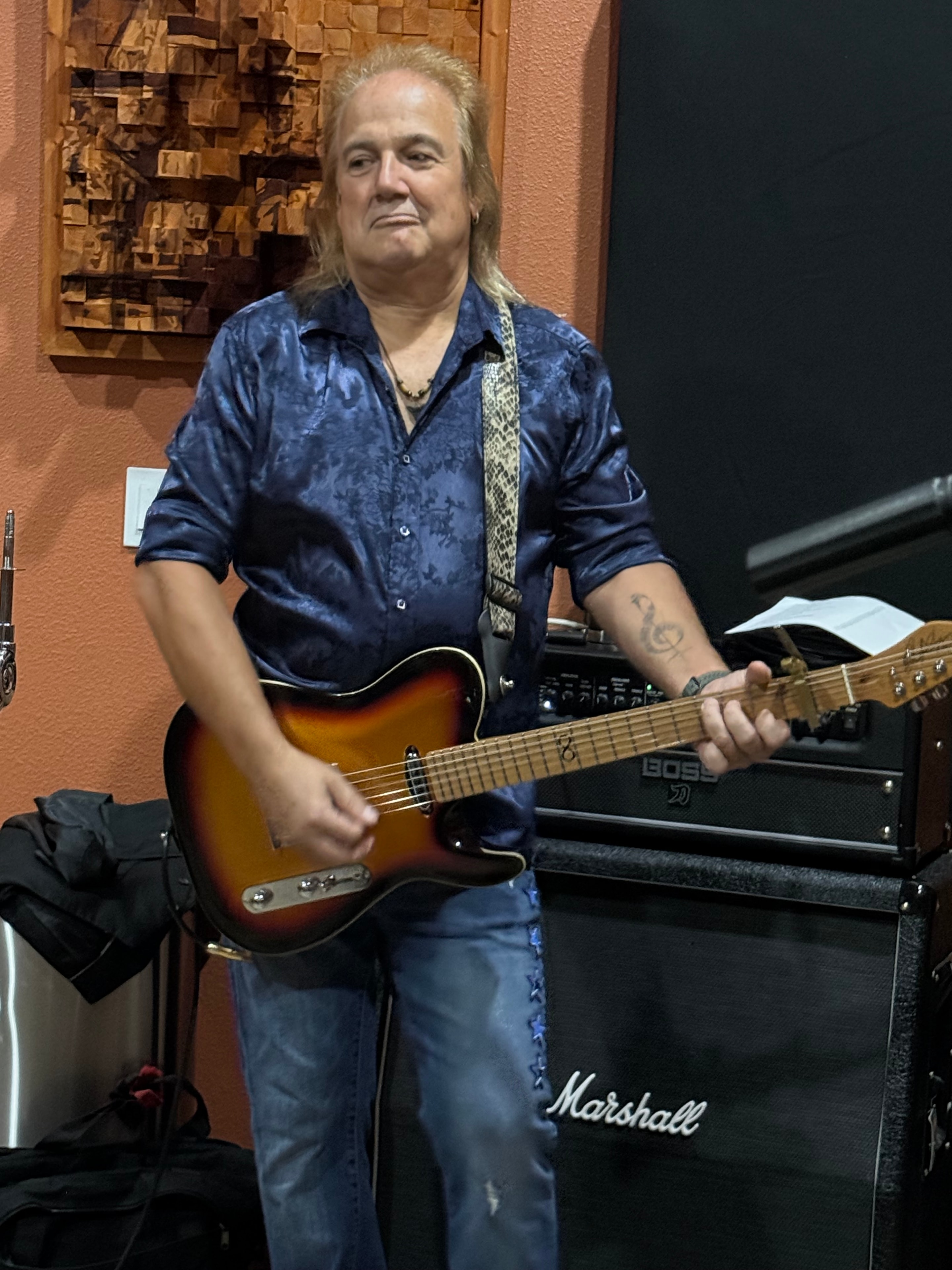 Guitarist with Telecaster in front of Marshall amp at rehearsal