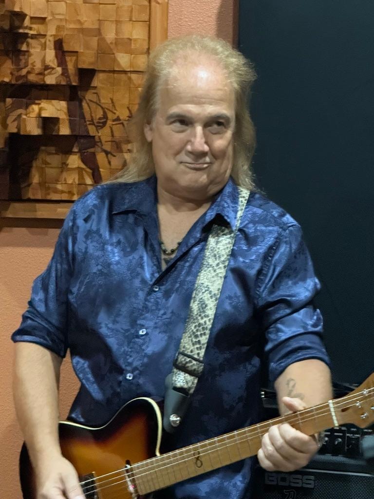 Jason Perry with guitar at rehearsal